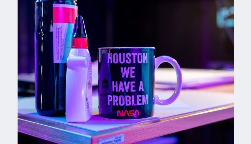 A cup stating "Houston We Have a Problem"