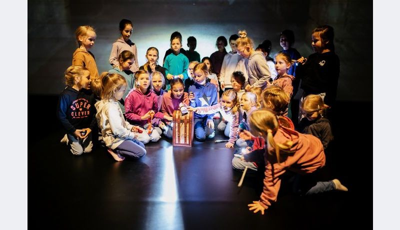 Kids sitting around a box