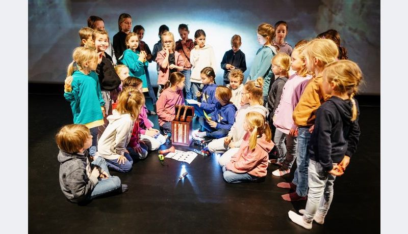 Kids sitting around a box