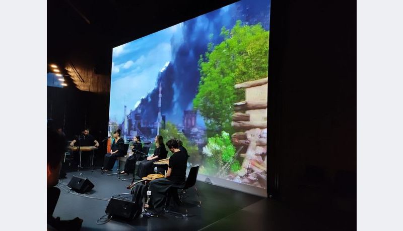 Musicians in front of a projection